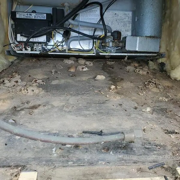 Water-damaged RV floor decking opened up for repair