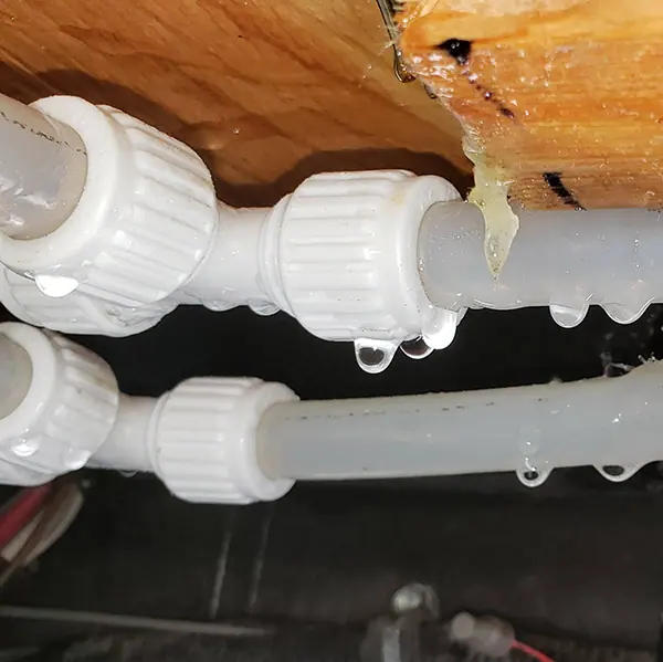 Leaking pipe fittings found under an RV floor