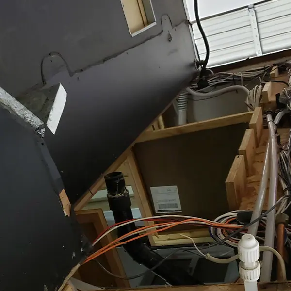 RV plumbing reached through an opened access panel
