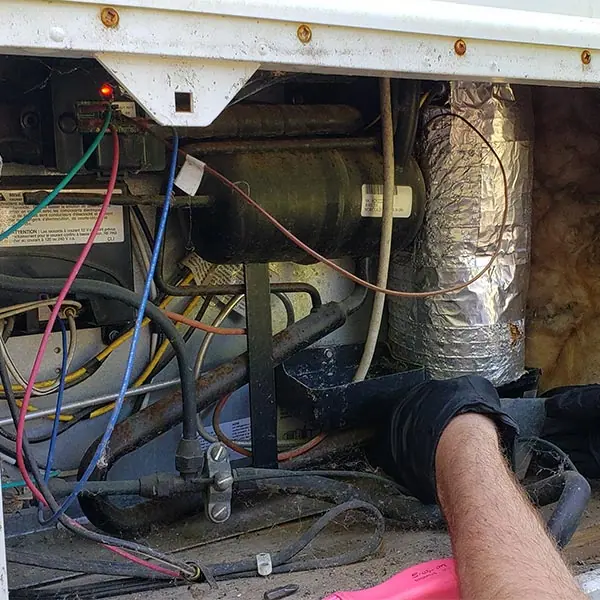 RV refrigerator compartment opened up for repair